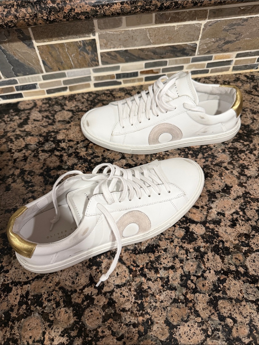white Oliver Cabell sneakers NWOT feature a distinctive gold heel counter